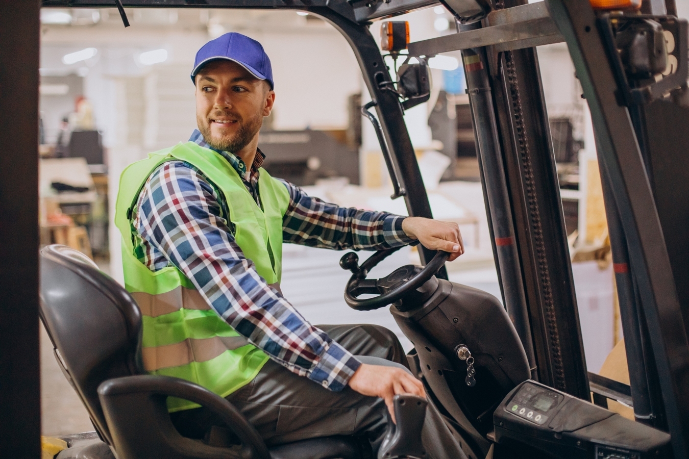 man-working-at-warehouse-and-driving-forklift